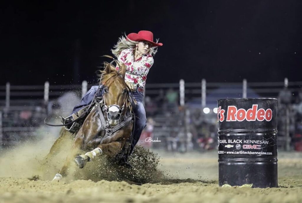 Madison Ann Iager gets low around a barrel