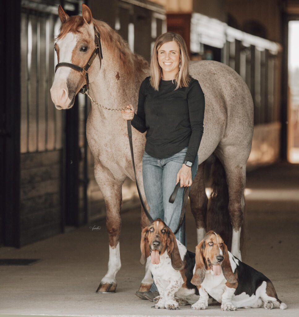 Melanie Smith poses with her horse and two dogs.