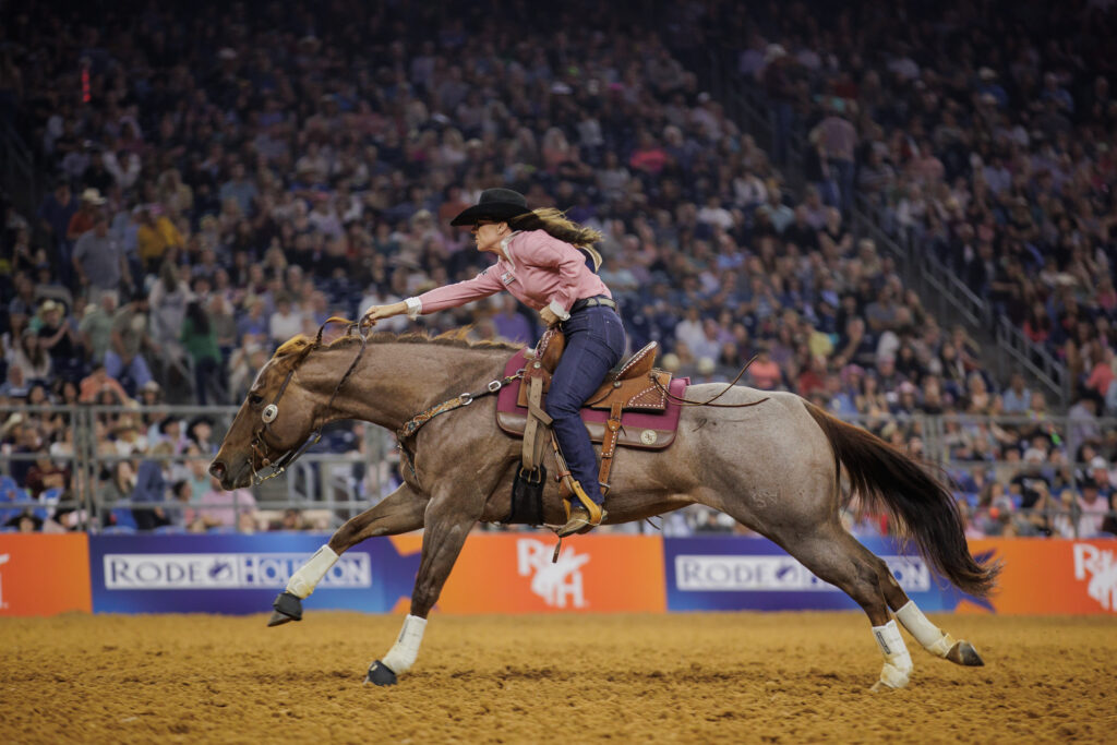 Andrea Busby completes a barrel racing run at RodeoHouston on Born on Derby Day.