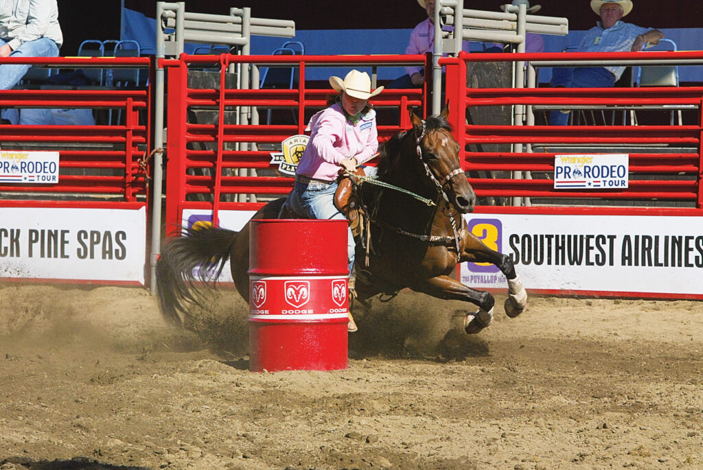 Shelley Murphy barrel racing at a rodeo.