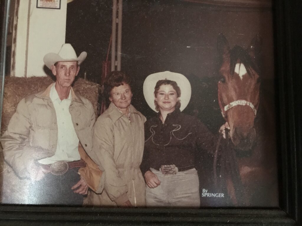 Bush family poses with great barrel racing horse.